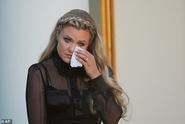 Erika Kirk wipes her eyes as a military aide reads the citation before President Donald Trump posthumously awards the Presidential Medal of Freedom