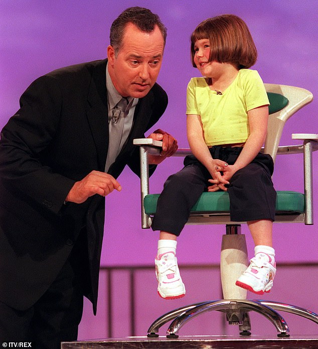 The presenter meets a young contestant on ITV show Kids Say The Funniest Things in 2000