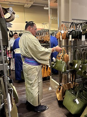 A wrestler browses handbags at TK Maxx