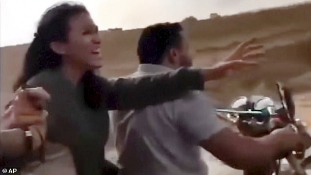 Noa Argamani reacts as she and her partner Avinatan Or, not pictured, are seized by members of the Hamas militant group during an incursion into Israel on Saturday, October 7, 2023