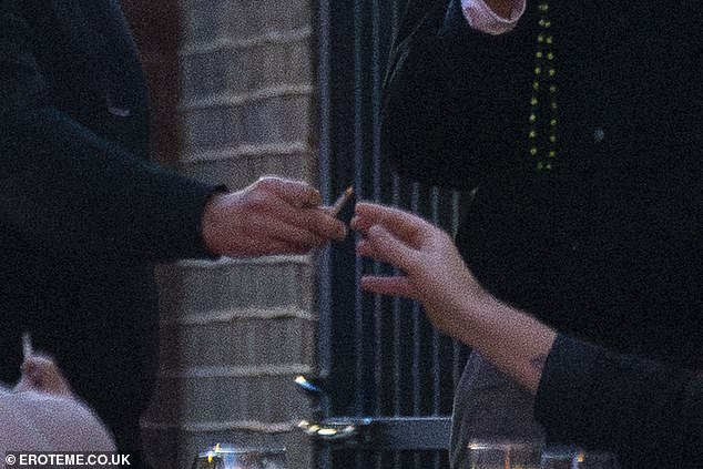 The gang appeared to pass a hand-rolled cigarette to one another during Sunday's outing