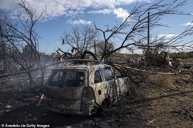 Firefighters extinguish a burning car after Russian ballistic missile attack on the Skhidny neighborhood of Sloviansk, Donetsk region, Ukraine on October 14, 2025