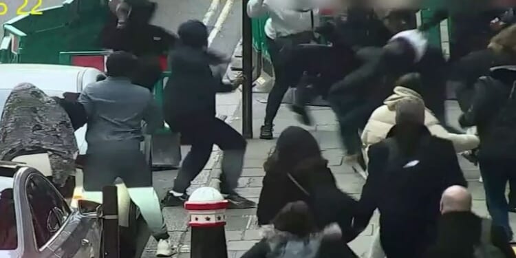 Chaotic moment yobs wielding CRUTCHES attack family in vicious brawl outside court