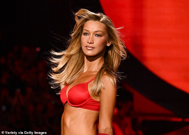 The supermodel made a grand entrance in a fiery crimson bra and lace thong while displaying a deep tan