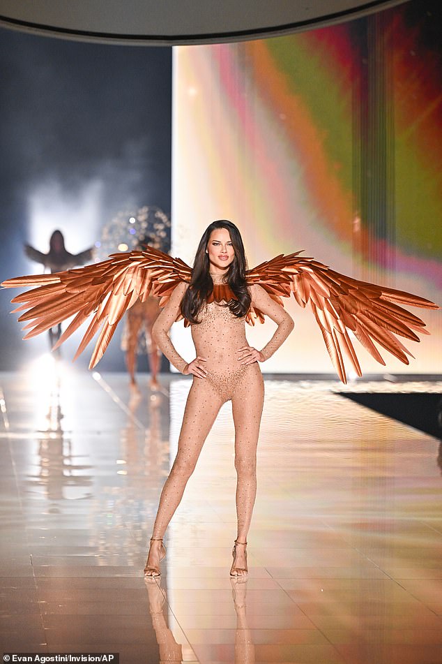 Adriana Lima made a stunning entrance in a sheer sequin-covered bodysuit with glittering underwear underneath that made it look almost as if she was walking out in the buff. She was decorated with copper-colored metallic wings