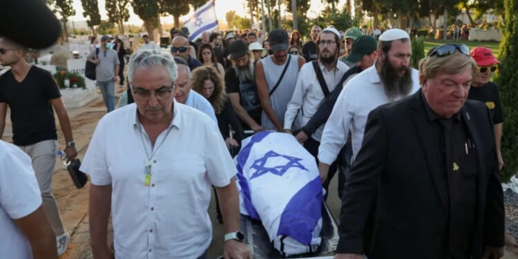 Israeli flag drapes coffin of hostage who died in Hamas captivity as his body is returned home