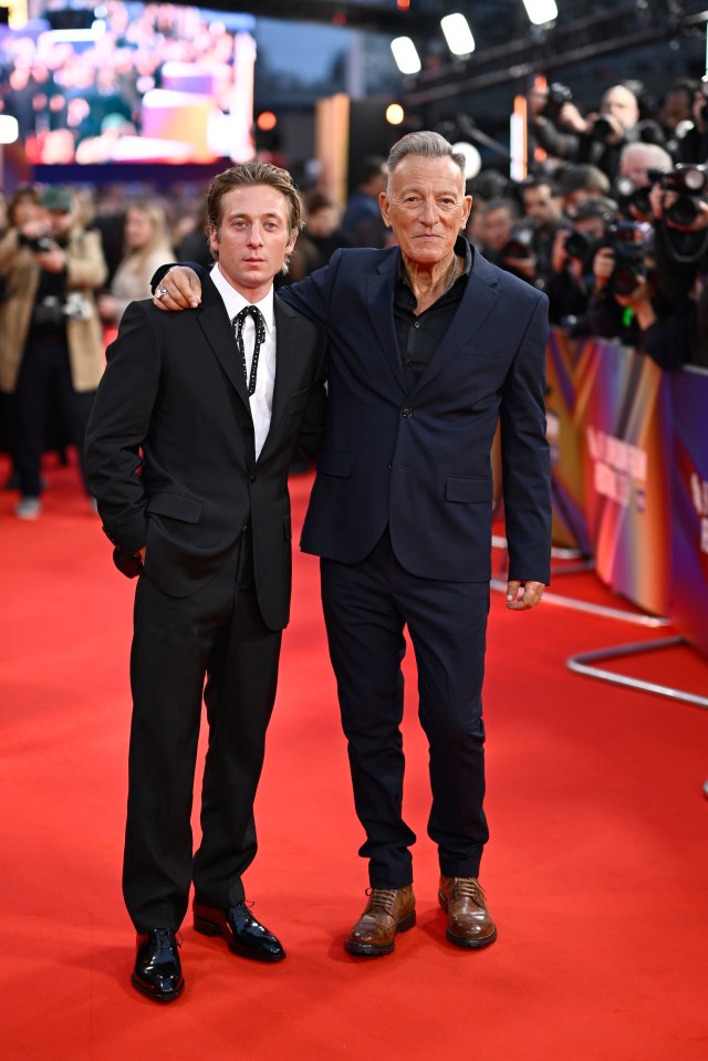 Jeremy Allen White and Bruce Springsteen posing together on a red carpet.