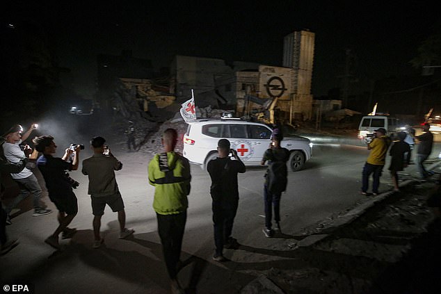 Vehicles of the International Committee of the Red Cross (ICRC) transporting remains of Israeli hostages handed over by Hamas leave in Gaza City
