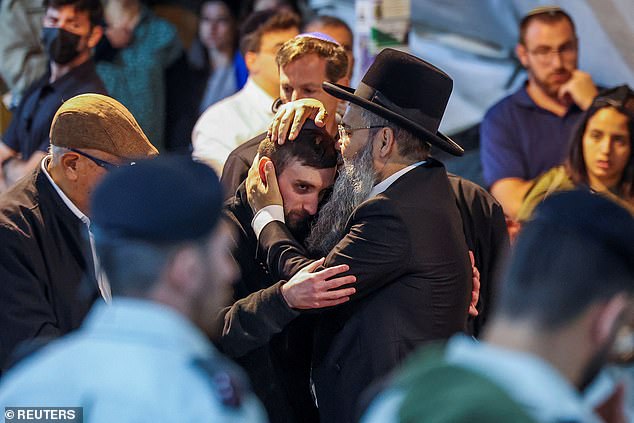 Released Israeli hostage Matan Angrest attends the funeral of Israeli soldier Daniel Shimon Perez
