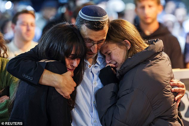 Adina Perez and Shira Perez react during the funeral of their brother, Israeli soldier Daniel Shimon Perez