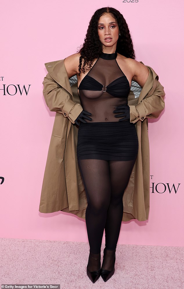 Actress Dascha Polanco wore a sheer black bodysuit paired with a black skirt and a small piece of fabric over her chest, which she paired with a trench coat