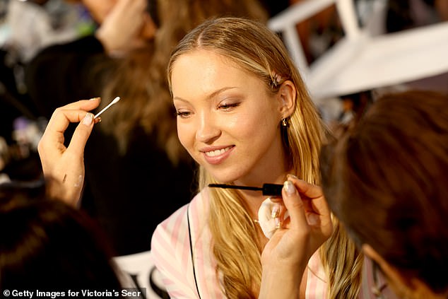The model beamed as she had the finishing touches to her makeup