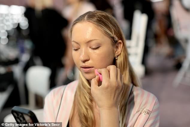Lila checked her phone backstage ahead of walking the catwalk