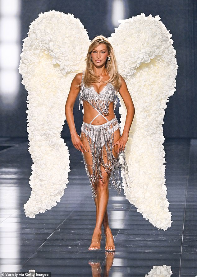 The tasseled garter skirt put the spotlight on her long, trim legs, and she completed her angelic look with a dramatic pair of white flower-covered wings that looked like clouds