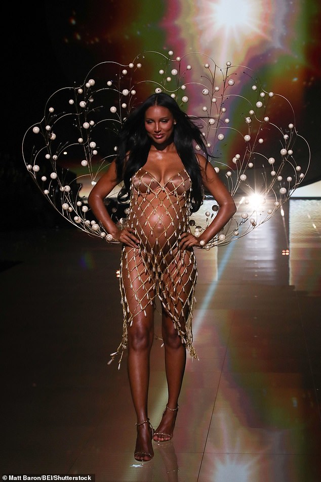 Jasmine Tookes kicked off the show by baring her heavily pregnant tummy in a golden mesh cover-up with a satiny brown bra and thong