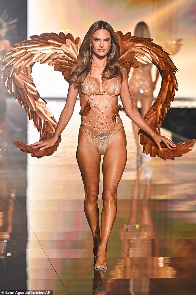 Alessandra Ambrosio looked lovely in a sheer beige monokini with clam-like designs protecting her modesty. The Brazilian catwalk star's top was connected by crisscrossing straps to its bottom, and she added a dramatic touch with heart-shaped wings with metallic wings
