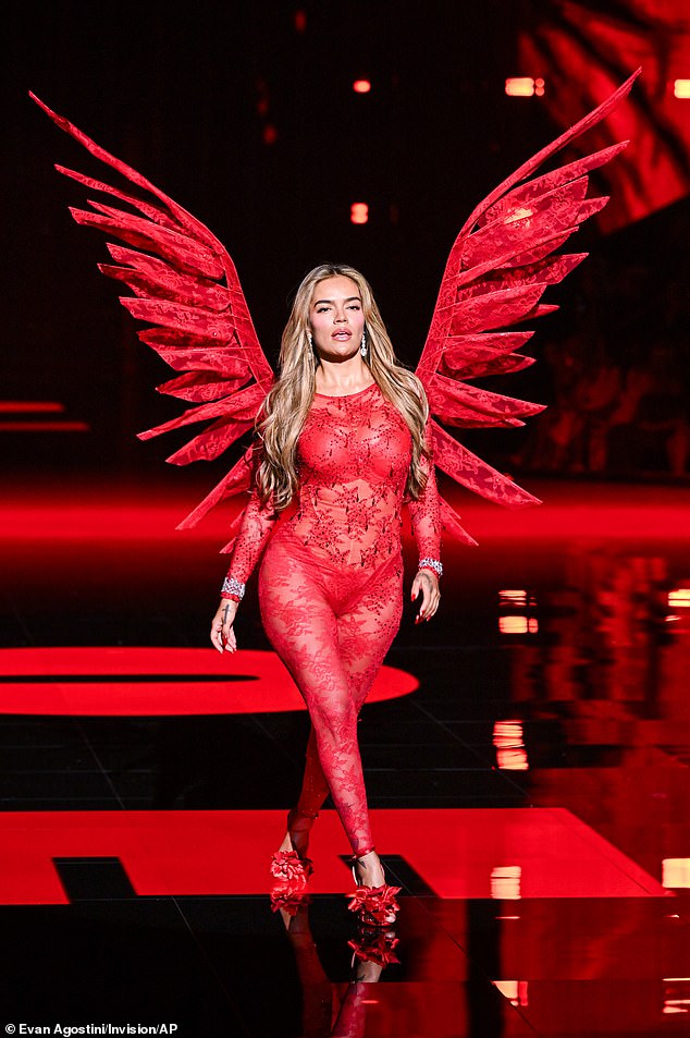 Another of the evening's musical performers, Karol G, created a stir when she walked the runway in a red satin bodysuit with angular knife-like wings and heels decorated with leaf-like flourishes