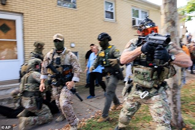 Government officials push back protesters in Chicago, Tuesday, October 14, 2025