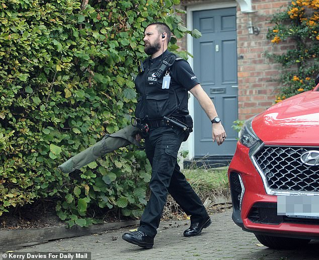 Items including what appear to be firearms were taken away