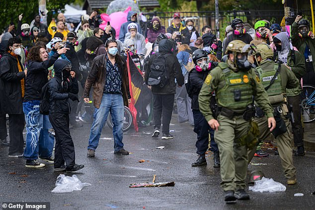 Protests have erupted across the nation in the wake of the administration's decision to send the National Guard across American cities (Pictured: A protest in Portland outside of an ICE building)