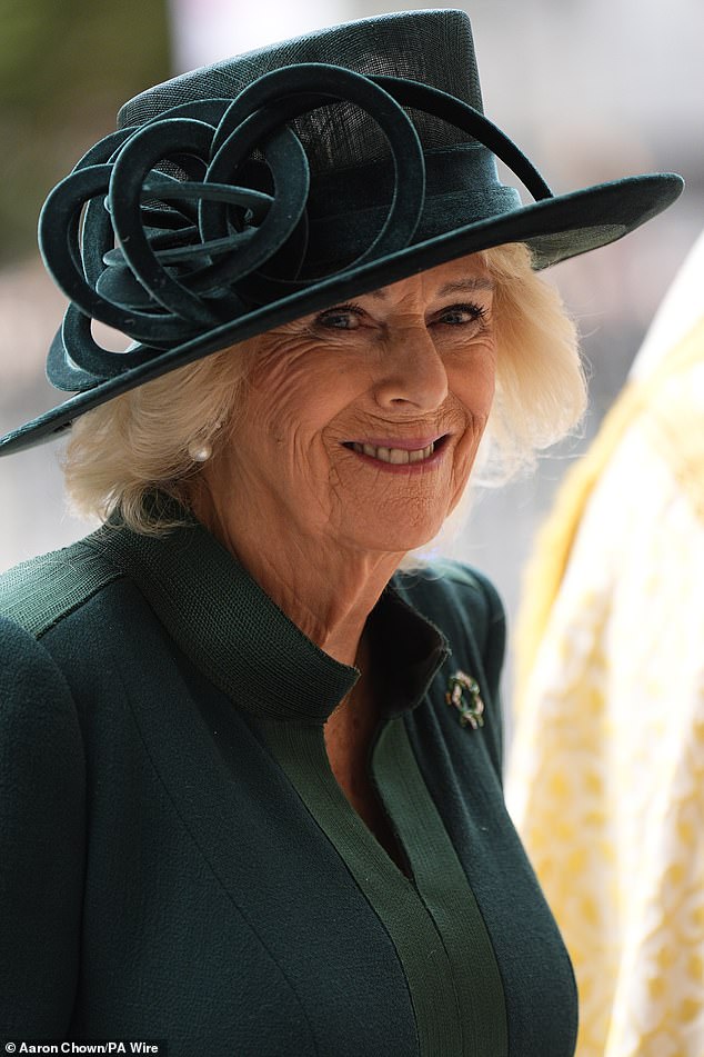Stepping out at Westminster Abbey in central London, she beamed beneath a deep emerald-green hat adorned with a velour accessory