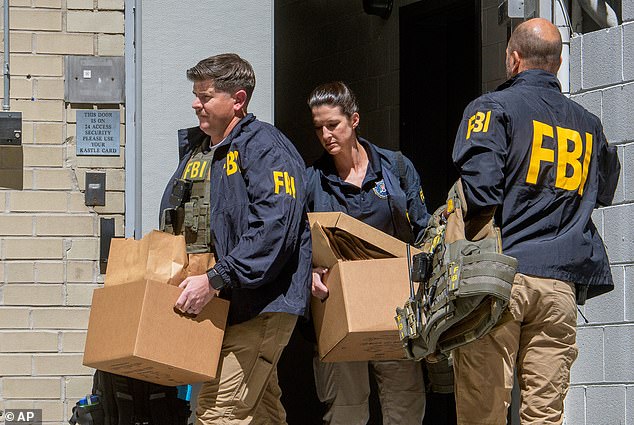 FBI agents remove boxes from the Washington, D.C. office of former Trump National Security Advisor John Bolton on August 22