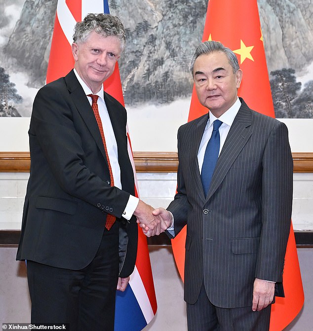 Wang Yi alongside Jonathan Powell, the British prime minister's national security adviser, in Beijing