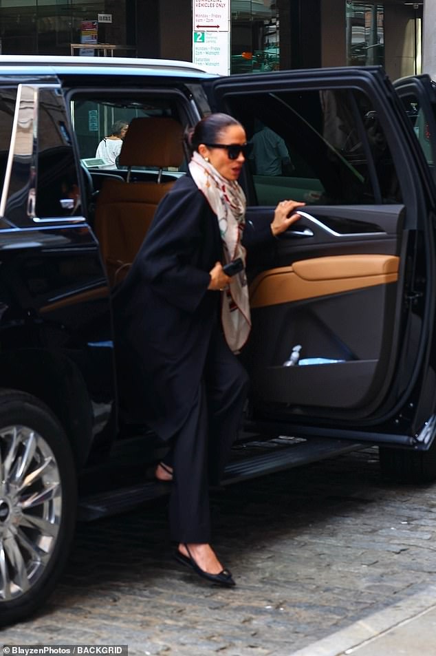 Meghan out and about on her own on Saturday in a different outfit