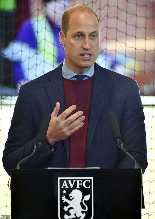 Prince William speaks to Aston Villa players during a visit to the club's training centre on 2021