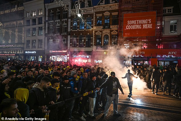 Fans of Maccabi Tel Aviv stage a pro-Israel demonstration in Amsterdam, lighting up flares and chanting slogans ahead of their Europa League match against Ajax on November 7, 2024