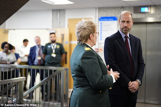 Aston Villa fan Prince William speaks with chief paramedic Pauline Cranmer during a visit to the London Ambulance Service at its headquarters in Waterloo this morning