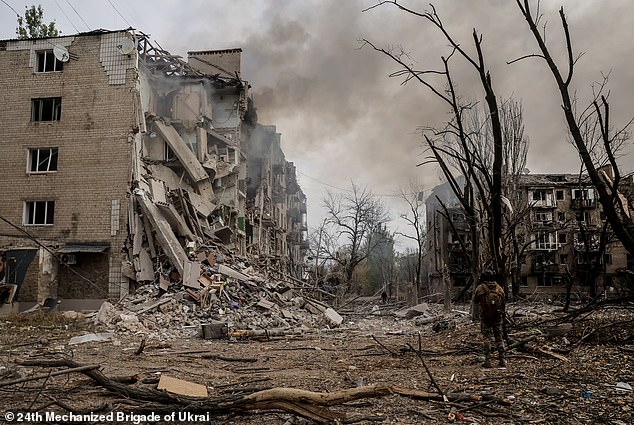 A Ukrainian soldier stands among the rubble in the courtyard of destroyed residential buildings in the frontline town of Kostyantynivka, Donetsk region, on October 12