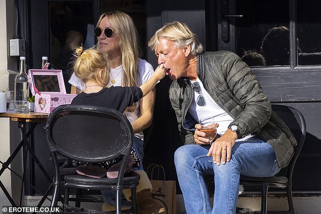 During lunch, Richard and Chloe appeared engaged in conversation before his granddaughter, Bodhi, sweetly fed him some of her fries
