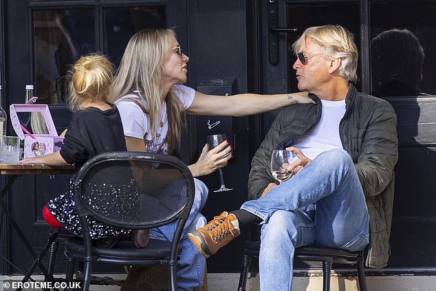 He cut a smart-casual figure for the outing, wearing a padded army-green coat paired with a plain white T-shirt and light blue denim jeans