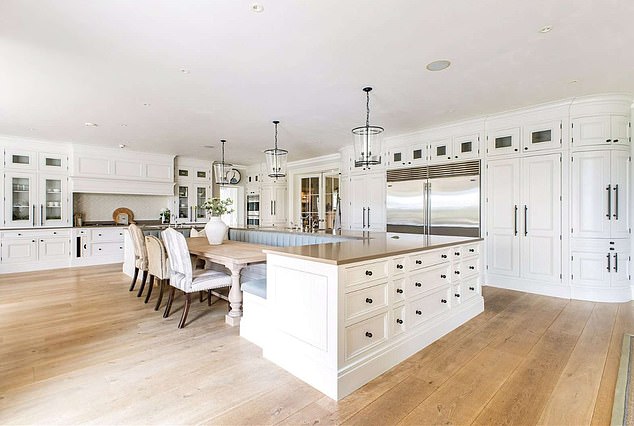 The stunning mansion has an open plan fitted kitchen complete with breakfast bar and snug area