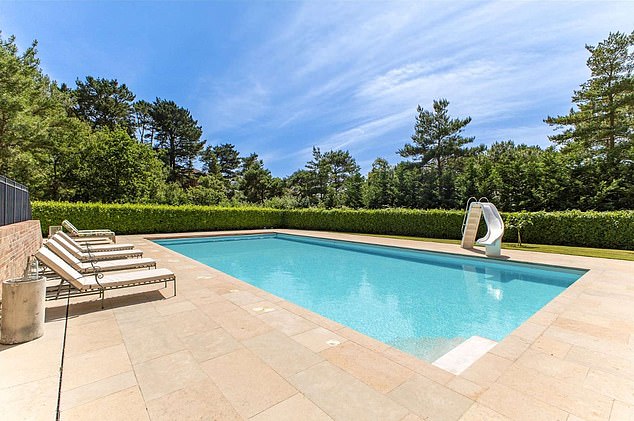 The house is set in extensive grounds and has a heated outdoor pool