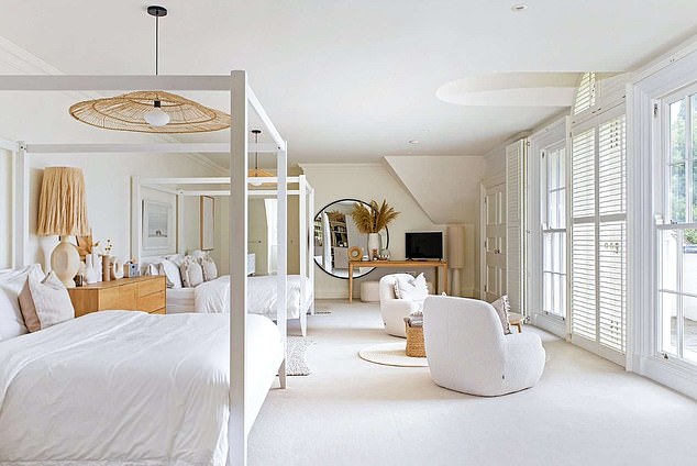 Pictured: one of the five bedrooms spread across the three-floored property, including two four poster beds and a balcony