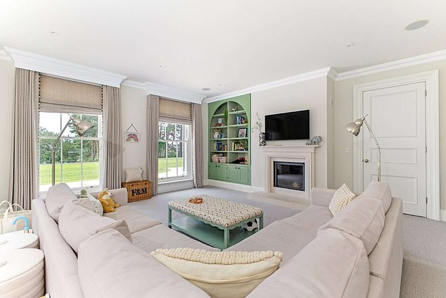 The lounge area has a huge sofa area, TV, and two floor-to-ceiling windows, making the rooms light and airy