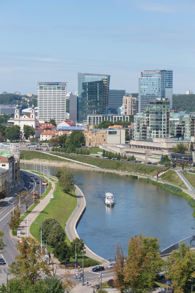 Aerial view of modern business part of Vilnius, Lithuania with a boat on the river.