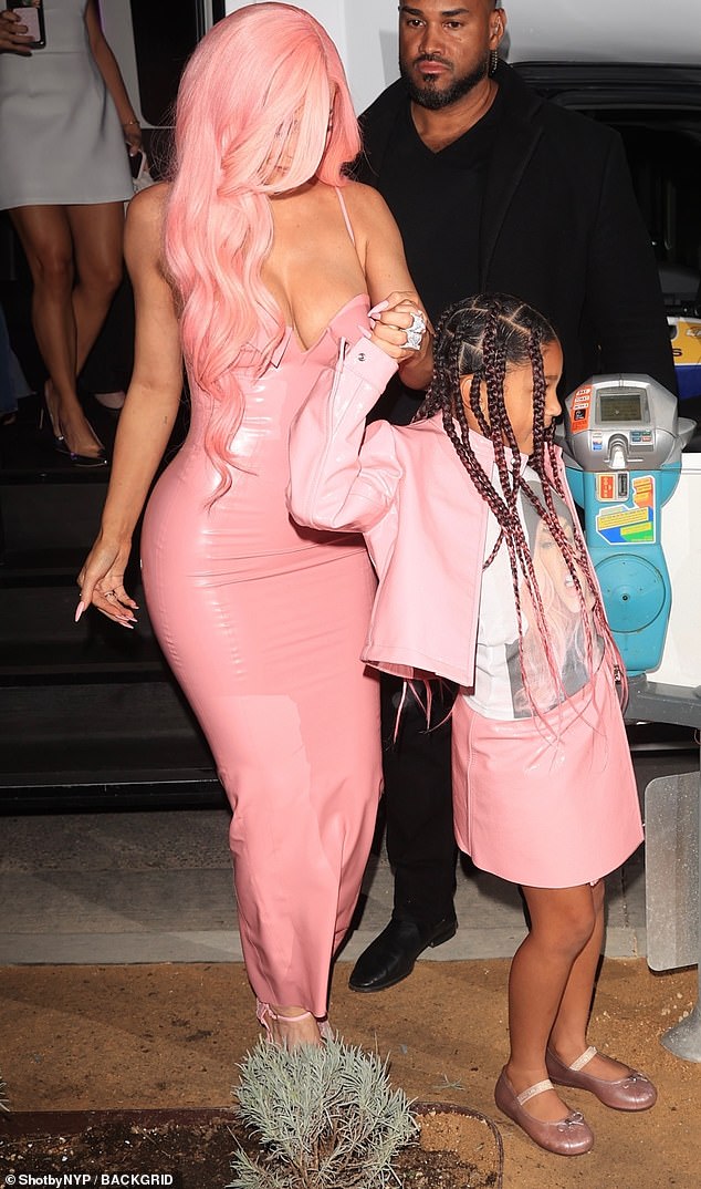 Stormi color-coordinated with her famous mother in a pink skirt and matching jacket. She also wore a printed shirt and pink flats