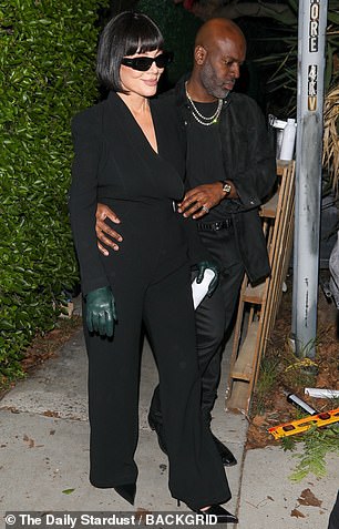 The reality star accessorized the ensemble with dangly silver earrings as well as stylish black sunglasses