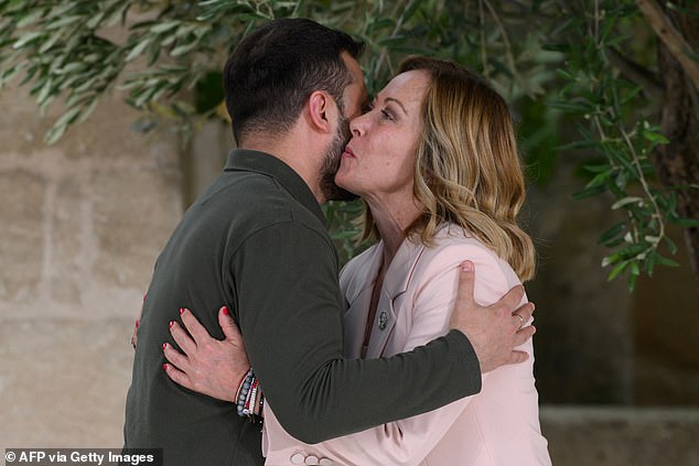 Ukrainian President Volodymyr Zelensky is welcomed by Italy's Prime Minister Giorgia Meloni as he arrives at the Borgo Egnazia resort for the G7 Summit hosted by Italy in Apulia region, on June 13, 2024 in Savelletri