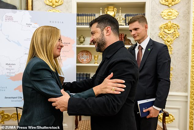 Ukrainian President Volodymyr Zelensky hugs Italian Prime Minister Giorgia Meloni after their meeting with President Donald Trump and other European leaders, Monday, August 18, 2025, in the Oval Office