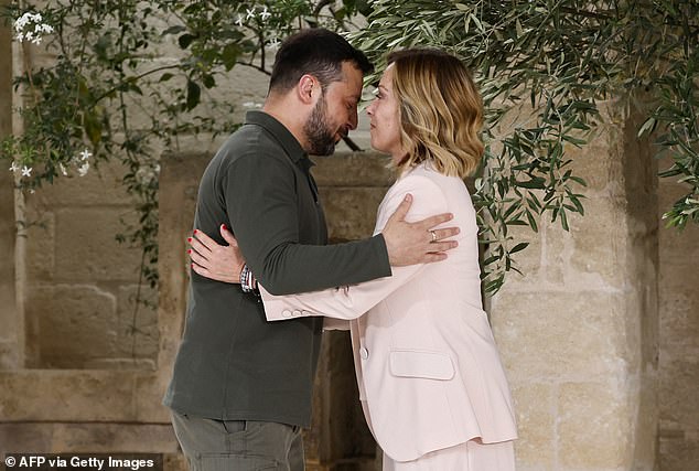 Ukraine's President Volodymyr Zelensky (L) is welcomed by Italy's Prime Minister Giorgia Meloni as he arrives at the Borgo Egnazia resort for the G7 Summit hosted by Italy in Apulia region, in Savelletri on June 13, 2024