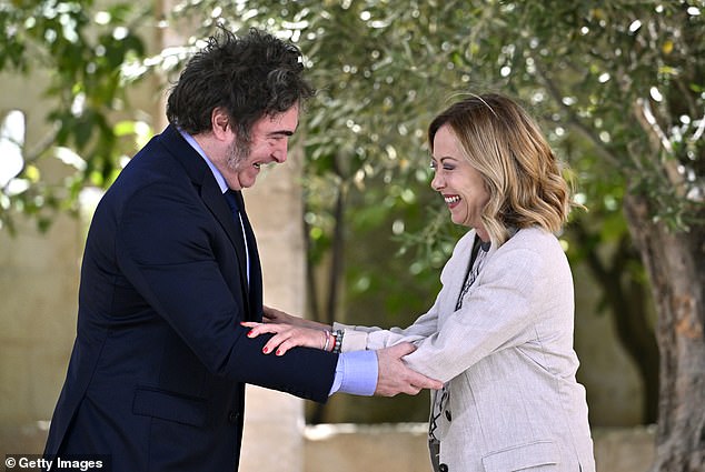 Argentinia's President Javier Milei clasps Meloni's arms as the pair greet one another in June, 2024