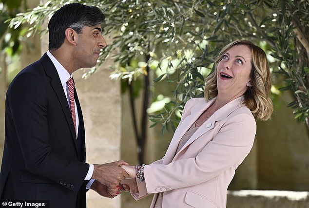 Sunak greets Italian Prime Minister Giorgia Meloni during a welcome ceremony on day one of the 50th G7 summit at Borgo Egnazia on June 13, 2024 in Fasano, Italy