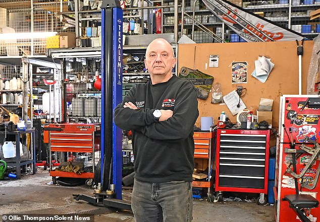 Neil Gibson at his car repair shop, which he began operating in 2009