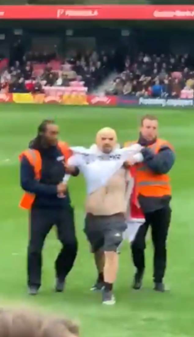 Footage also showed one fan being escorted off the pitch by two stewards at Moor Lane