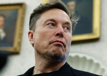 Elon Musk listens as reporters ask President Donald Trump questions at the White House in Washington, DC on May 21, 2025.