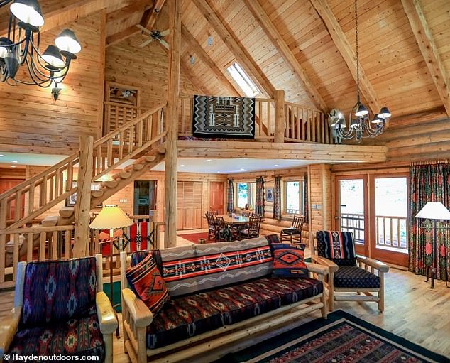 The Bighorn Mountain Ranch boasts a five-bedroom, four-bathroom log home (pictured), a cookhouse cabin with space for two and three additional cabins that could sleep four to six more people